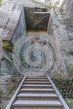 Mount Nokogiri Ã©â¹Â¸Ã¥Â±Â± tall relief image of Kannon deity Goddess of mercy carved into an old edo period quarry wall photo